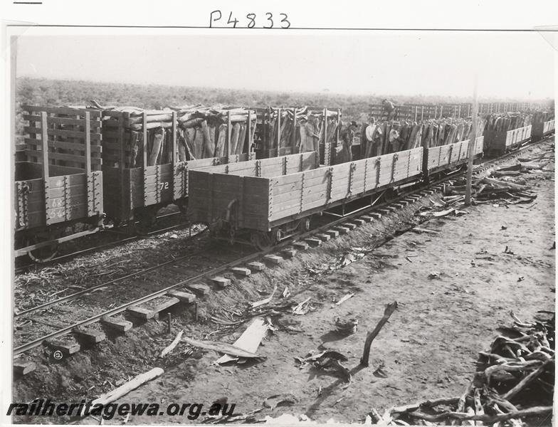 P04833
R class wagons, WAGFS Co. 4 wheel, wagons, Kurrawang, being loaded with firewood 
