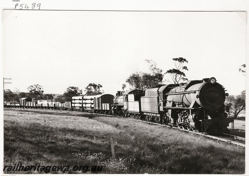 P05489
V class 1203 tender to tender with P class 508, heading to Narrogin, GSR line, goods train. Steel underframed GC class 6364 first wagon in the train.
