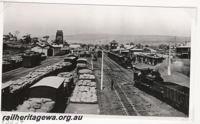 P05534
Station yard with loaded wagons, scissors crossover with double slip, station building, signal box, goods shed and the 50,000 gallon water tower, Northam, ER line, elevated overall view taken from the footbridge looking west,
