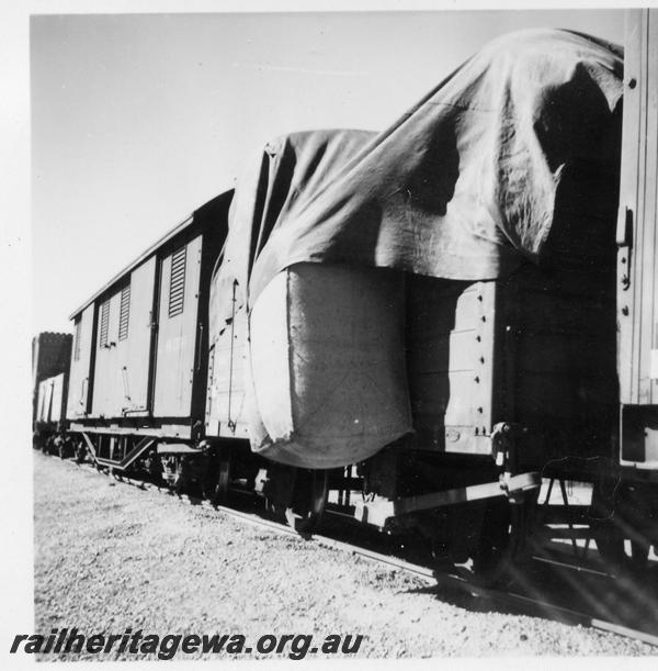 P06031
Bale of wool fallen off wagon and being held on by the ropes of the tarpaulin, on No.76 goods
