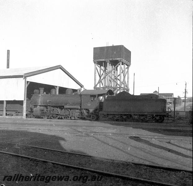 P06073
L class, loco shed, water tower, loco depot, Geraldton, side and end view, loco missing a set of driving wheels
