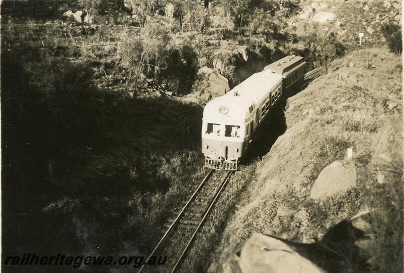 P06340
ADE class, near tunnel, ER line, front and side view, towing an AG class Gilbert car as a trailer, view looking down on track..
