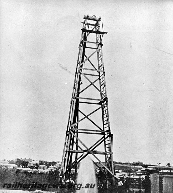 P06714
Artesian bore for railway purposes, Perth Goods Yard, shows derrick and water gushing out of the ground
