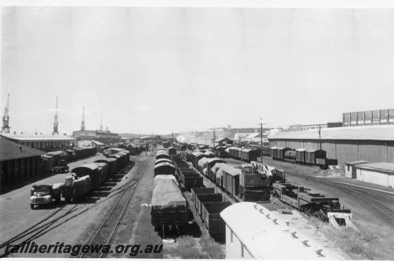 P06757
Yard, Fremantle, looking east, E shed and passenger terminal in background, QX class 2300 trolley wagon in foreground
