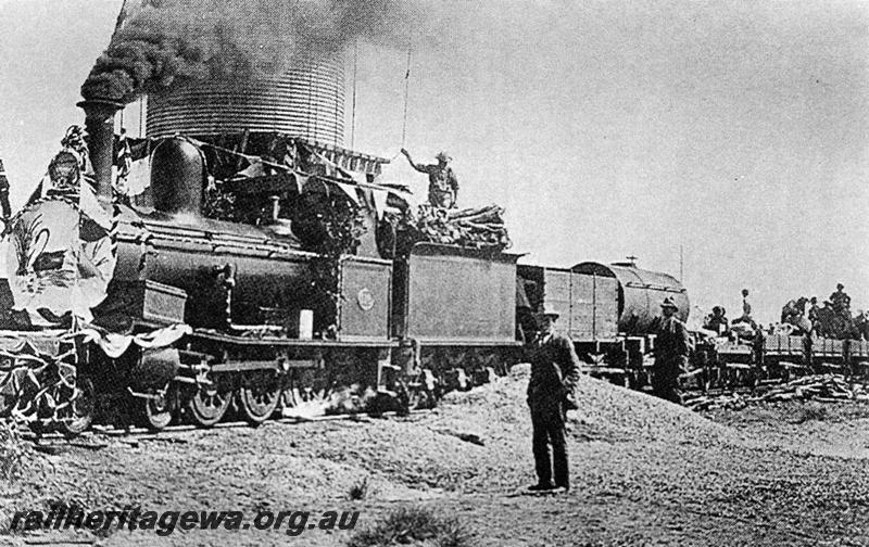 P06765
G class 118, water tower, Shaw River, PM line, possibly on the train celebrating the opening of the Port Hedland to Marble Bar Railway. Loco decorated for the occasion.
