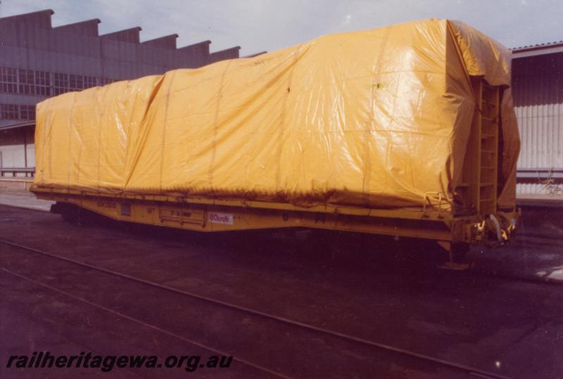 P06792
QUW class 25013, flat wagon adapted for transporting wool bales, side and end view showing load covered with tarpaulins.
