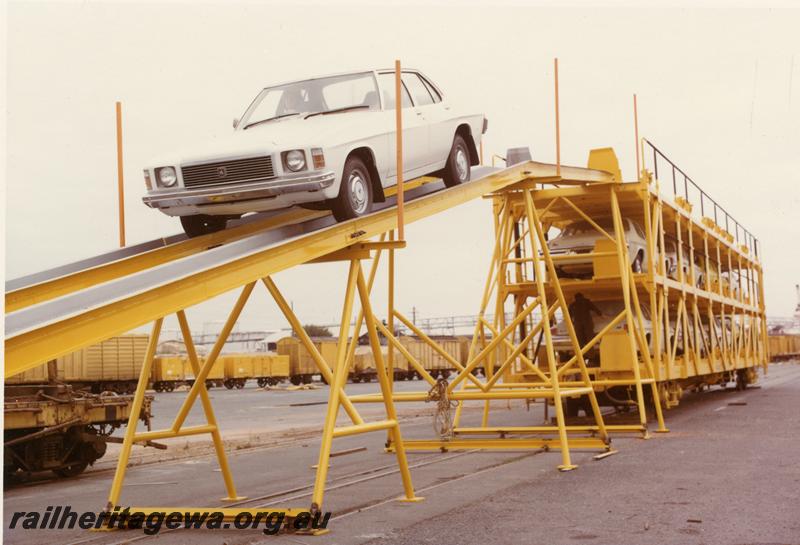 P06950
WMB class standard gauge motor vehicle carrying wagon, end and side view, car being driven off top deck onto unloading ramp.
