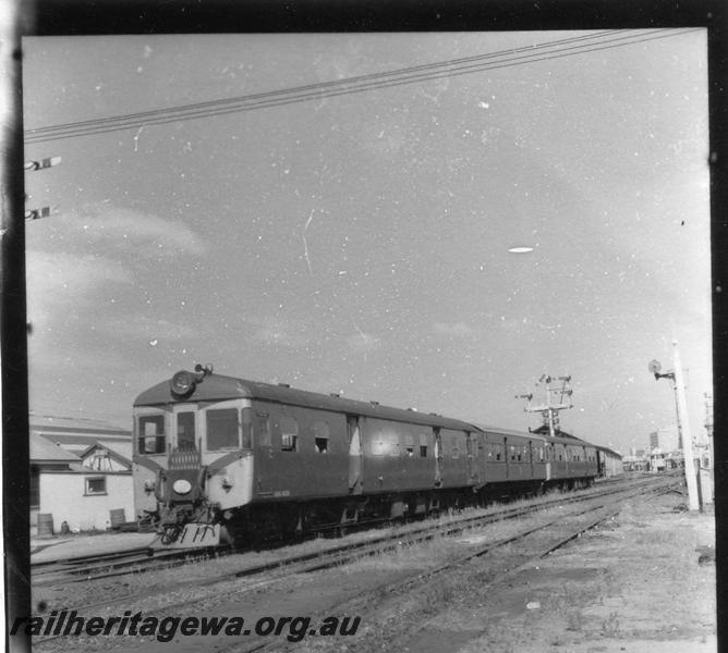 P06981
ADG/AYE/ADG class railcar set, No.6 platform, Perth Yard, in green livery with red chevrons on front, view looking east.
