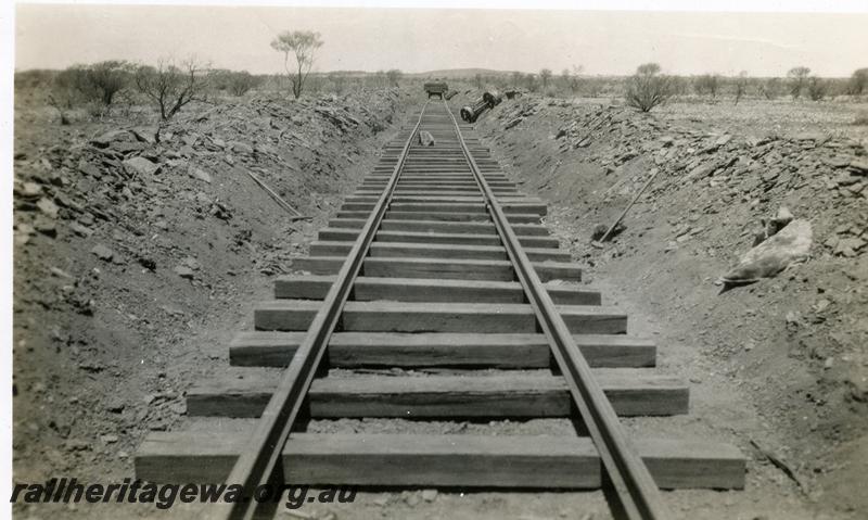 P07015
4 of 7 photos of the construction of the Cue - Big Bell railway, NR line, shows newly laid track in shallow cutting awaiting spiking
