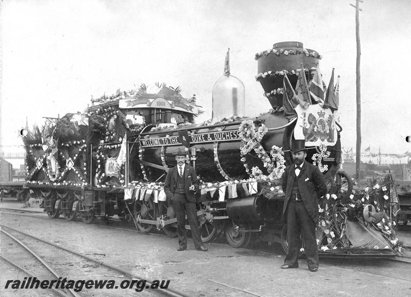 P07188
G class loco decorated for the visit of the Duke and Duchess of York, the decorator Mr Frank Cook standing at the front of the loco, side and front view
