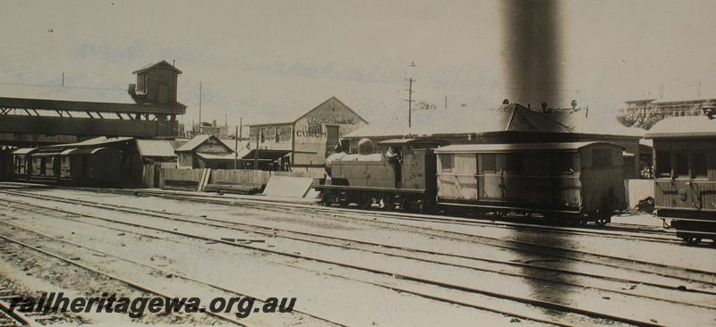 P07239
N class loco with VA class van, Perth Yard with over bridge to the Parcels Office in background.
