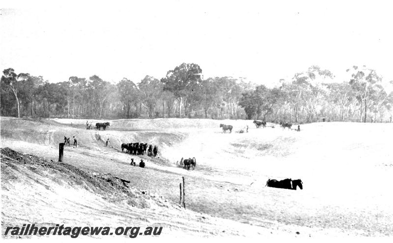 P07313
9 of 32 photos of the construction of the railway dam at Hillman, BN line, excavation from S.E. corner, shows horse teams at work.
