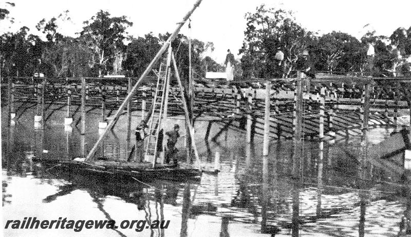 P07326
22 of 32 photos of the construction of the railway dam at Hillman, BN line, roof structure under construction, workers on barge
