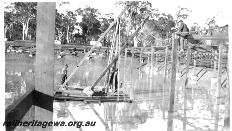 P07328
24 of 32 photos of the construction of the railway dam at Hillman, BN line, construction of roof, workers on barge with derrick
