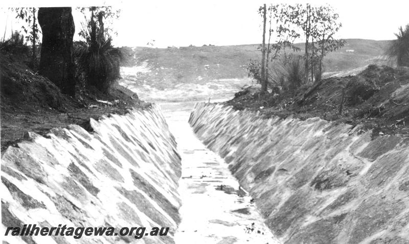 P07334
30 of 32 photos of the construction of the railway dam at Hillman, BN line, looking along rock lined channel towards Main Rock
