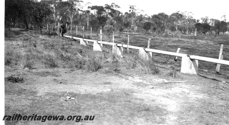 P07345
9 of 15 views of the construction of the railway dam at Williams, BN line, Fibrolite water pipeline supported on concrete piers
