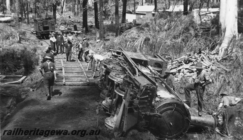 P08070
I of 4 views of Kauri Timber Co. loco No.109?, derailed, bush line out of Nannup, loco on side with workers. (Ref: 