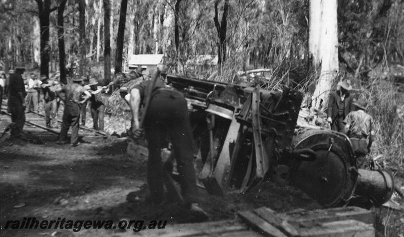 P08071
2 of 4 views of Kauri Timber Co. loco No.109?, derailed, bush line out of Nannup, loco on side with workers 
