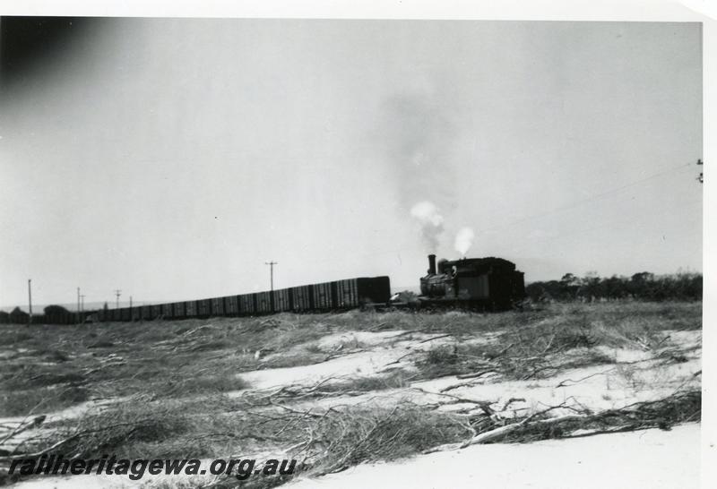 P08106
1 of 3 views of G class 233 struggling with a long rake of GH class coal wagons between the Bunbury Power House and the old Bunbury Station on the original rail connection, fireman is scooping up sand and placing it on the rails.
