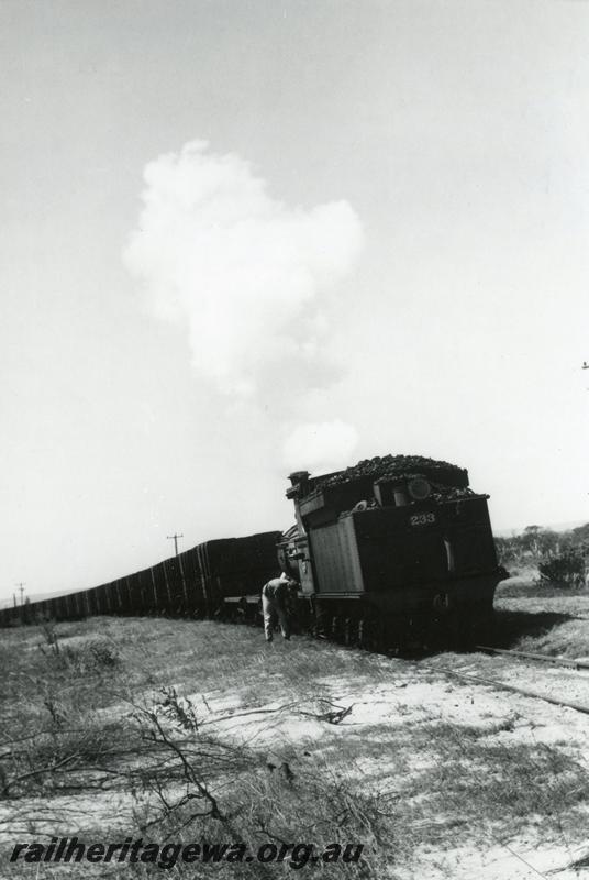 P08107
2 of 3 views of G class 233 struggling with a long rake of GH class coal wagons between the Bunbury Power House and the old Bunbury Station on the original rail connection, fireman is scooping up sand and placing it on the rails.
