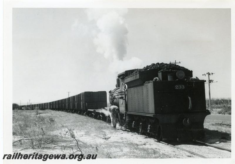 P08110
G class 233 struggling with a long rake of GH class coal wagons between the Bunbury Power House and the old Bunbury Station on the original rail connection, fireman is scooping up sand and placing it on the rails.
