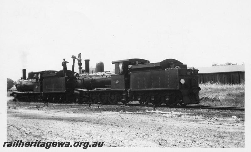 P08126
3 of 3 views of G class 118 hauling G class 67 from Bunbury to Midland, Yarloop, SWR line, taking water, side and rear view.
