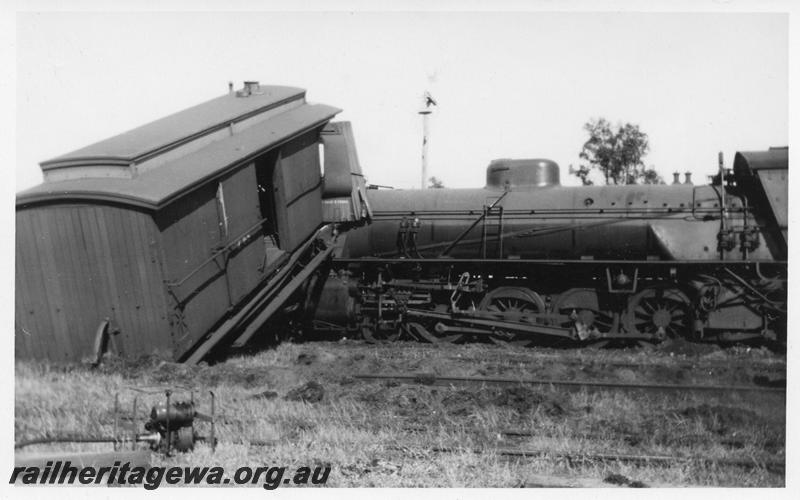 P08132
1 of 7 views of the collision at Yarloop, SWR line, by a train headed by W class 951 and a stationary goods train. Z class 65 clerestory roofed brakevan at right angles to the track with its end on top of the W class
