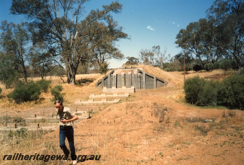 P08180
Bridge abutments and supports of dismantled bridge, Boyup Brook, DK line, member Jeff Austin in foreground.
