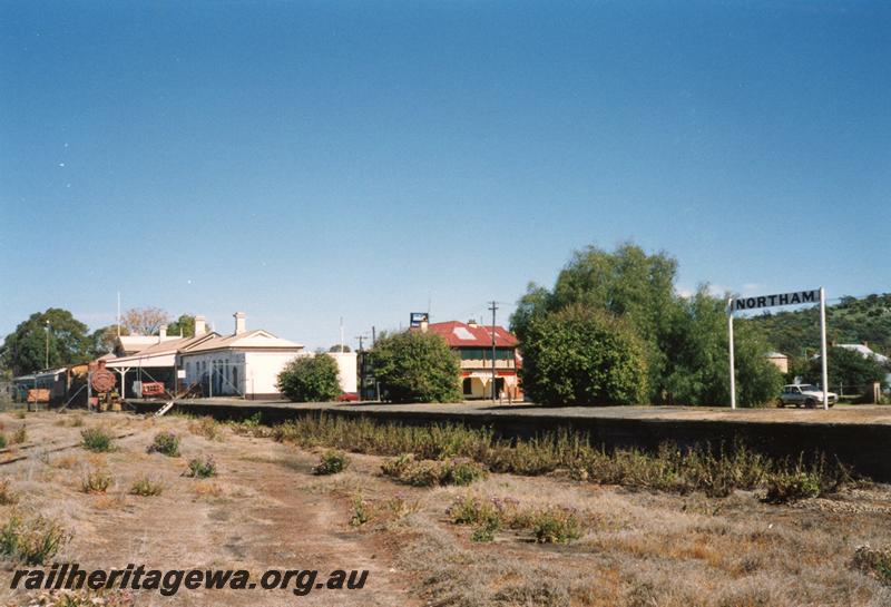 P08481
Northam, station building, platform, nameboard, narrow gauge, view from yard, preserved rail equipment visible, ER line.
