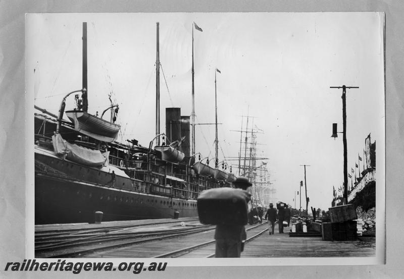 P08713
Wharf, Fremantle?, tracks in foreground, ship tied up at the wharf, windjammers in the background.

