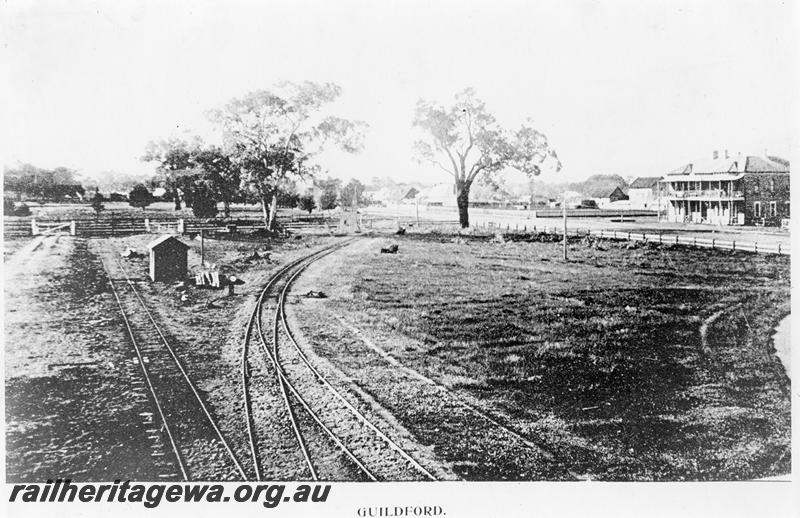 P09551
Original terminus of the Eastern Railway at Guildford, view shows the extension to Chidlow's Well curving away to the right to travel along Ellen street, now Johnson Street. Guildford Hotel seen in background
