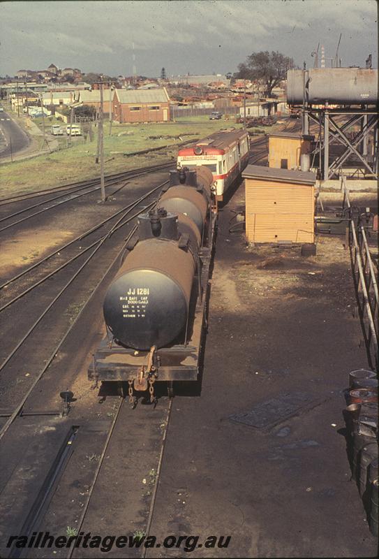 P09735
ADF class, 'Bunbury Belle' headboard, shunting oil wagons, diesel refuelling area East Perth loco shed. ER line.
