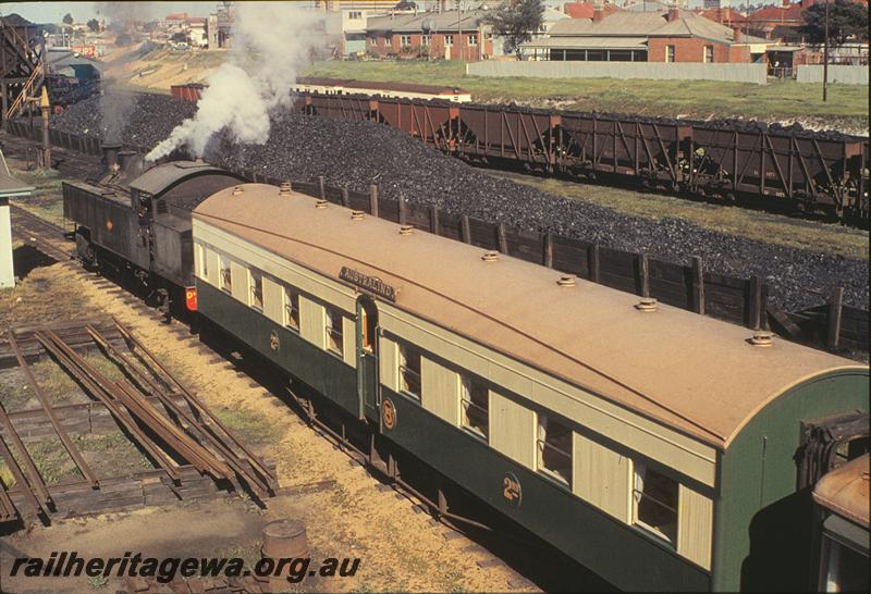 P09741
DM class, shunting AYC class 510 and ALT class 5 onto turntable, coal dumps and XA wagons in background, East Perth loco shed. ER line.
