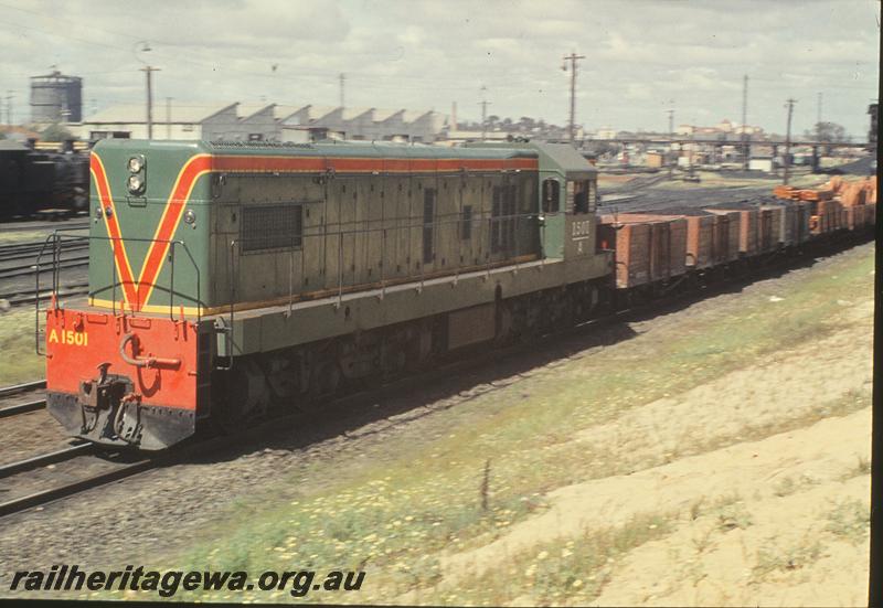 P09832
A class 1501, down goods, loco yard and Summers St bridge in background. East Perth loco shed. ER line.
