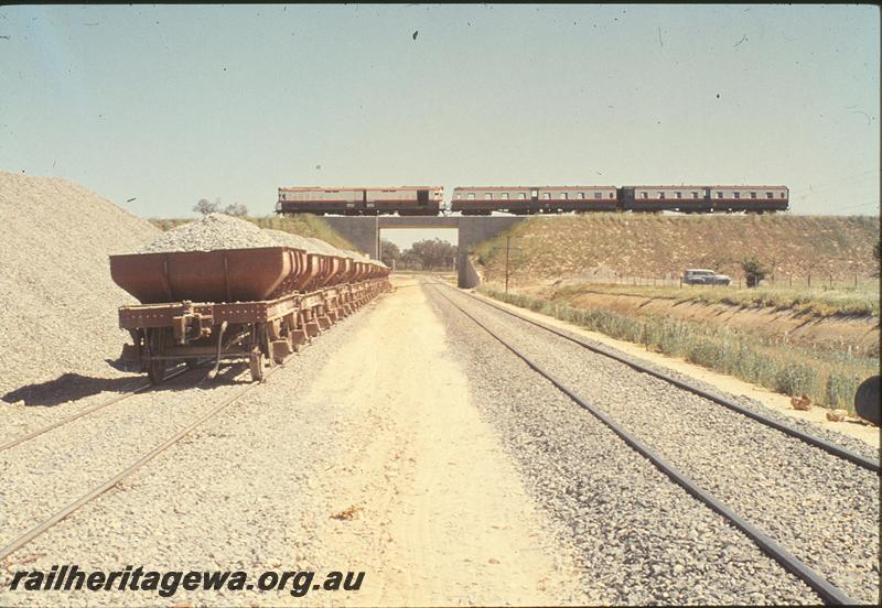 P09874
ADF class, 'Bunbury Belle' on Kenwick Flyover, WSJ class ballast hoppers on line going under bridge. Forrestfield - Fremantle line.
