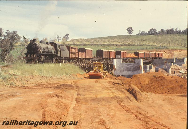 P09908
W class, ex MRWA wagon in consist, down goods, on trestle, new bridge under construction, Balingup. PP line.
