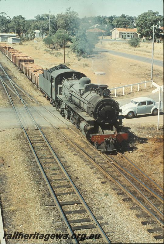 P09988
PMR class 733, down goods, level crossing, shunting at south end of Armadale. SWR line. With a train of loaded wagons with sleepers
