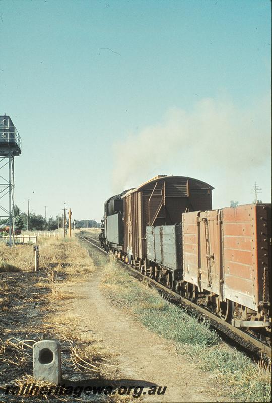 P09994
PMR class 724, up goods, water tower, water column, back of signals, 54 mile peg, ex MRWA AC class wagon, departing Pinjarra. SWR line.
