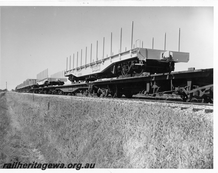 P10237
WF class standard gauge flat wagon with side stanchions (later reclassified to WFDY), being transported upon a pair of narrow gauge flat wagons, side and end view
