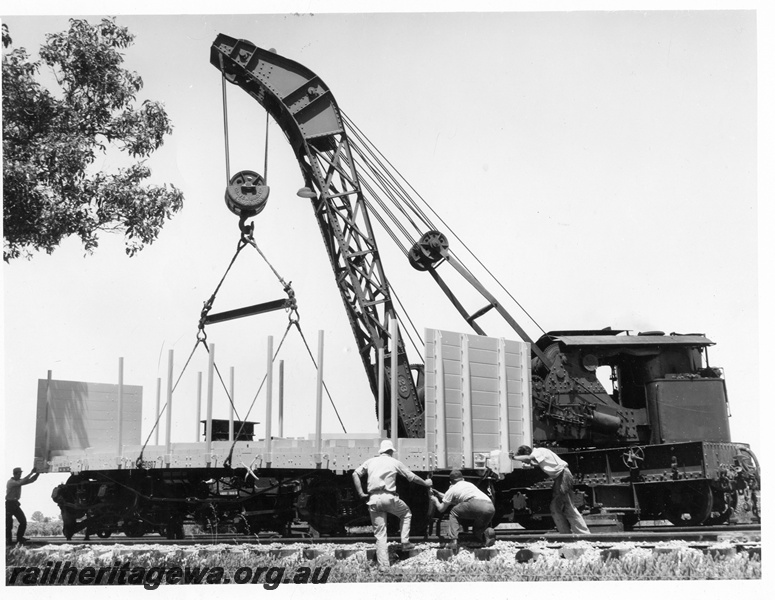 P10246
Cravens 25T breakdown crane No 23 lowering a WSF class standard gauge flat wagon with end bulkheads onto the track, side and end view
