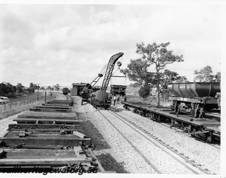 P10249
Cravens 25T breakdown crane No 23 lifting an ex Commonwealth Railways (CR) four wheel ballast wagon from a narrow gauge flat wagon
