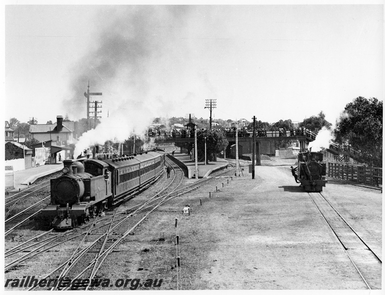 P10261
D class on Royal Show special working departing for Perth from Claremont Station, N class loco in the yard, large numbers of intending passengers on the footbridge, view looking down the track towards the station
