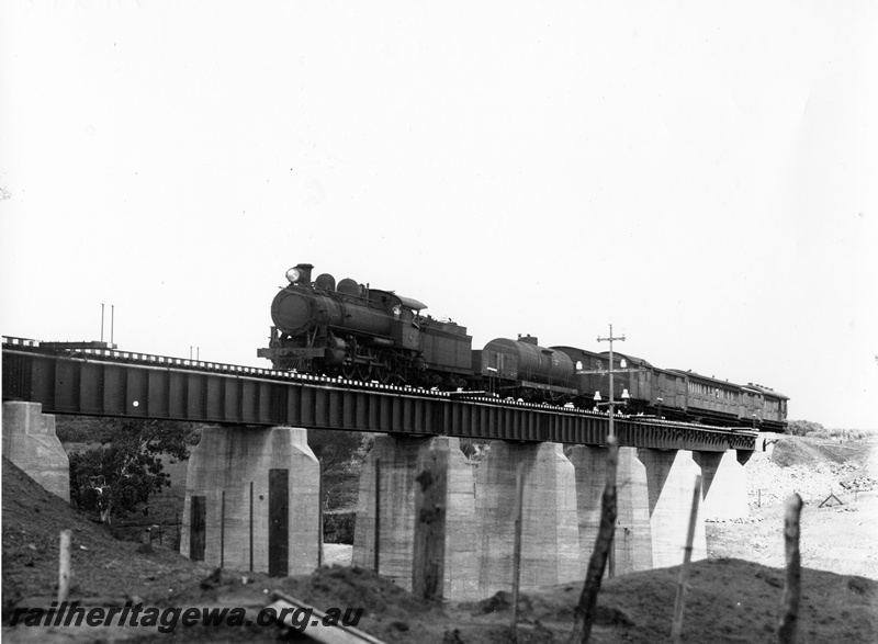 P10265
L class steam loco, steel girder bridge on concrete pylons, Eradu, NR line, on short mixed train, view of train on the bridge, same as P7833 but better quality.
