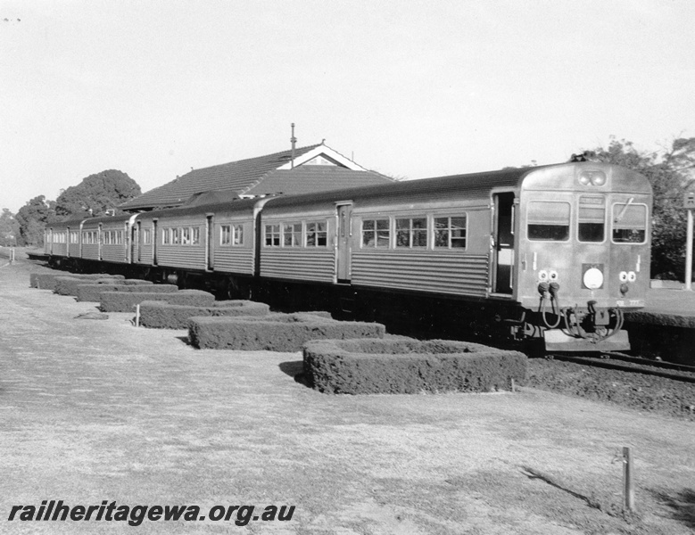 P10312
ADK/ADB class four car railcar set, station building, Daglish, shows the hedges forming the name of the station
