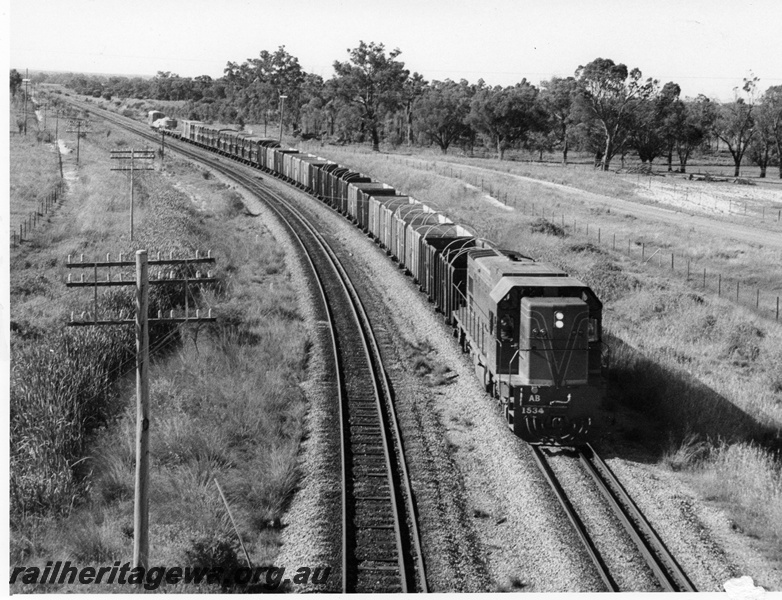 P10331
AB class 1534 in green livery on a train of mainly empty high sided open wagons with sheep wagons towards the rear of the train, elevated view looking south from the Kalamunda over bridge, High Wycombe
