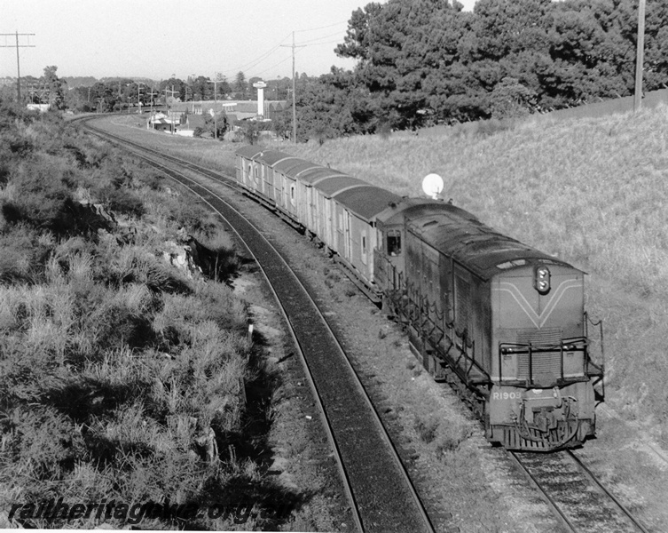 P10339
R class 1903 diesel locomotive in green with red and yellow stripe livery, passing show grounds heading towards Perth with short train of mostly guard (brake) vans. 
