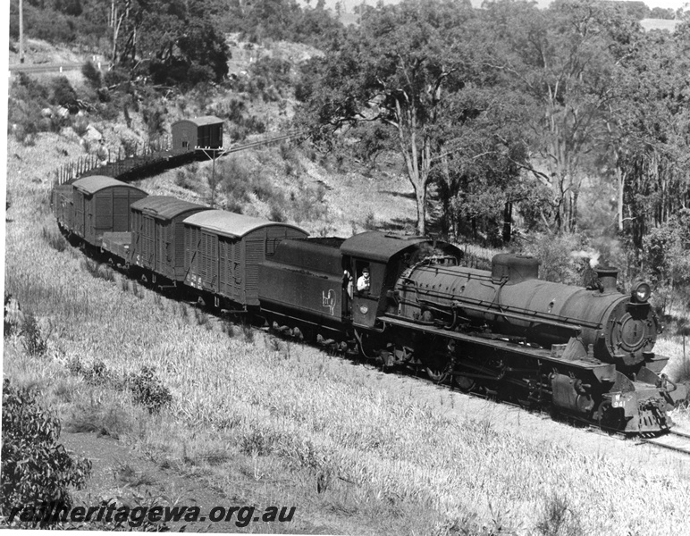P10340
W class 941 steam locomotive on the once a week goods train to Dwellingup, conveying empty timber wagons and covered vans, passing through one of the many curves on the line.

