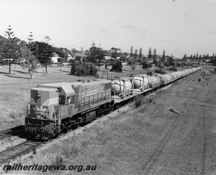 P10344
DA class 1576 in the Westrail Orange Livery, hauling mainly tarpaulin covered 4 wheel wagons, departing Cottesloe towards Perth.
