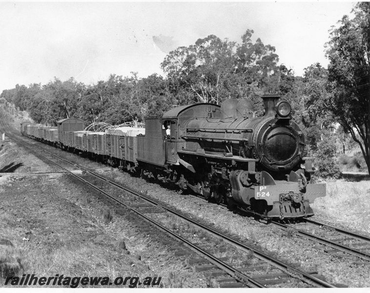 P10355
PR class 525 (Fitzroy). En route from York to Midland Number 6 goods with nearly all grain loading leaving Chidlow on old EGR line, three quarter view taken in bushland setting.
