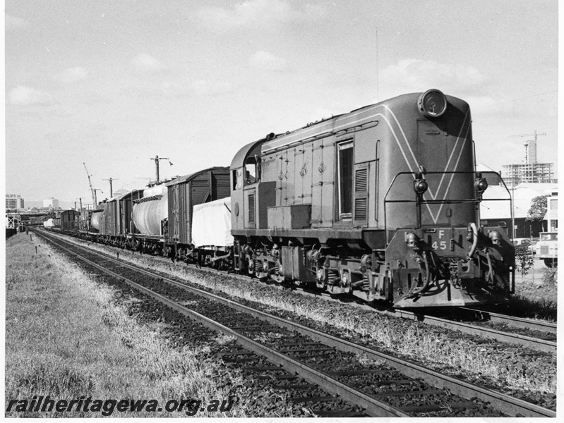 P10362
F class 45, green with red stripe livery, long hood leading suburban goods, Fremantle on up main. 
